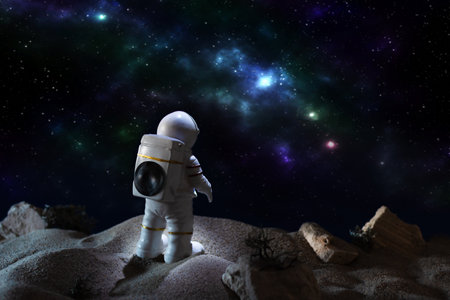 Astronaut in a space suit looking at milky way galaxy.の写真素材
