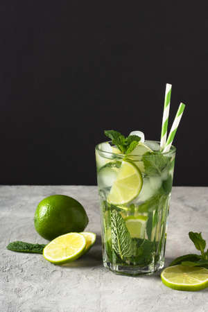 Refreshing summer mojito cocktail with ice cubes, fresh mint and lime. A glass of cold mojito drink.の写真素材
