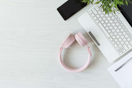 Table with laptop, headphone and notebook top view. Working or studying desk. E-learning education.の写真素材