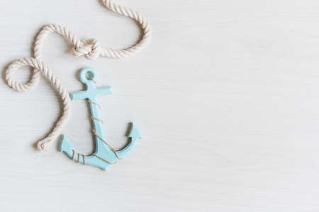 Sea background with anchor and marine rope on white wooden deck top view. Summertime sea background.の写真素材