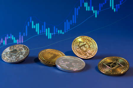 Various cryptocurrency coins with bitcoin in the centre on blue background. Cryptocurrency, virtual...