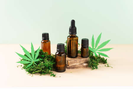Various glass bottles of CBD oil, THC tincture over modern background. Cosmetics CBD oil. Droplet bottles of cannabis oil extract.の写真素材