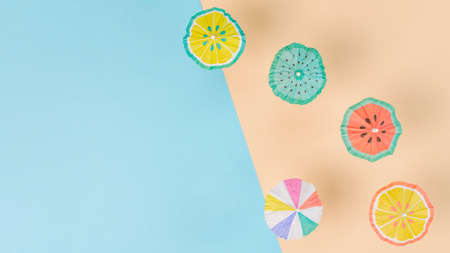 Creative paper craft of many sunshade umbrellas on a paper sandy beach. Summer vacation concept....