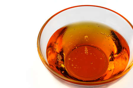 Healthy organic honey in a bowl on white background. Sweet honey healthy dessert.の写真素材