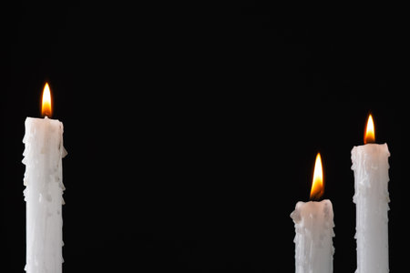 Burning candles over dark background. Halloween background with candles.の写真素材