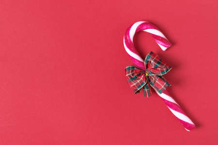 Christmas background with candy cane on red. Christmas greeting card.の写真素材