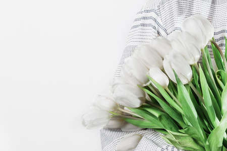 Woman hands holding bouquet of white tulips. Spring tulip flowers. Flower postcard.の写真素材