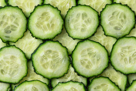 Background with many slices of cucumber. Fresh slices of cucumber.の写真素材