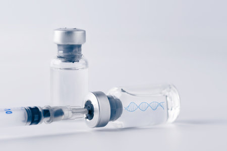 Glass vial and syringe with injection over white background. Vaccination or beauty therapy concept.の写真素材