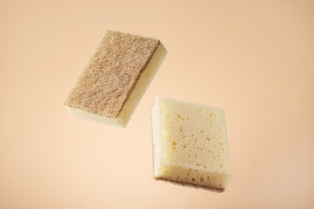 Natural dishwashing sponge over beige background. Eco friendly housework objects.の写真素材