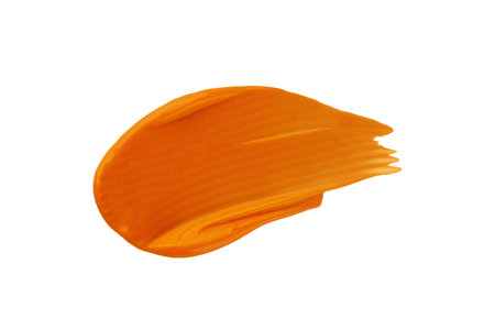 Smear of orange cream. Sunscreen cream swatch isolated on white background. Swatch of vitamin C face mask.の写真素材