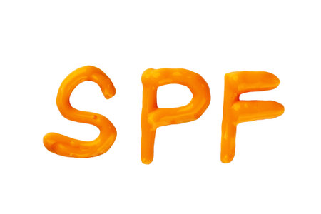 SPF cream. Orange sunscreen cream isolated on white background. Creative idea of suntan lotion cream. Sun UV protection concept.の写真素材