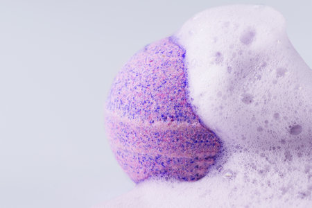 Pink bath bomb with soap on white background closeup. Sea salt in a ball shape for beauty spa treatment and body care.の写真素材