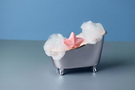 Salt bath bomb in a bathtub with soap suds. Creative idea of bath bombs or soap for body care beauty spa treatment.の写真素材