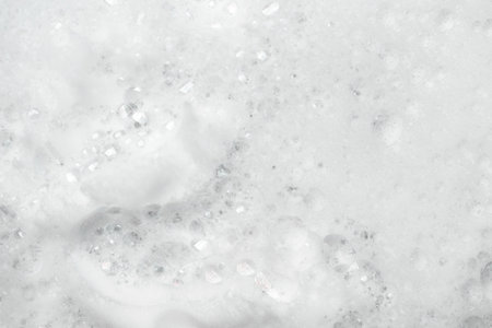 White soap foam background. Shampoo foam texture with bubbles.の写真素材