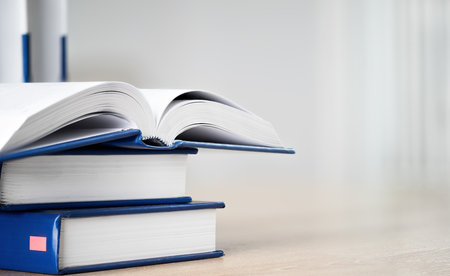 Stack of books with open book on table with copy space. Books background for business and education...