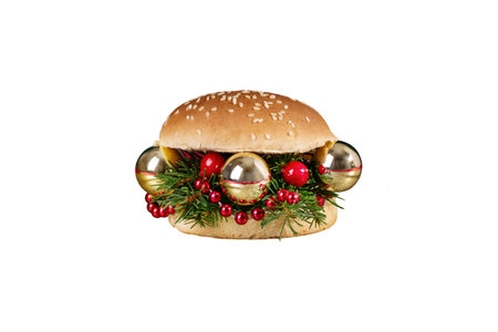 Creative Christmas hamburger. Burger made from fir branches and Christmas ornaments isolated on white background. Creative New Year or Christmas food concept.の写真素材