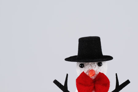 Snowman in a hat over white background. Merry Christmas and Happy New Year greeting holiday card. Christmas holiday wallpaper.の写真素材