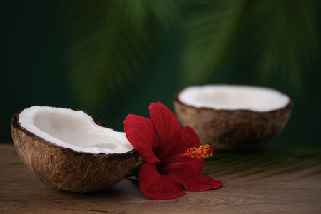 Half of coconut with coconut water on wooden table. Tropical summer healthy coconut cocktail.の写真素材