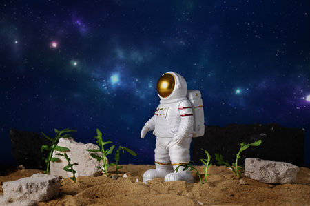 Agriculture technologies in space concept. Astronaut growing plants on alien planet. Since fiction, imagination about gardening on mars planet.の写真素材