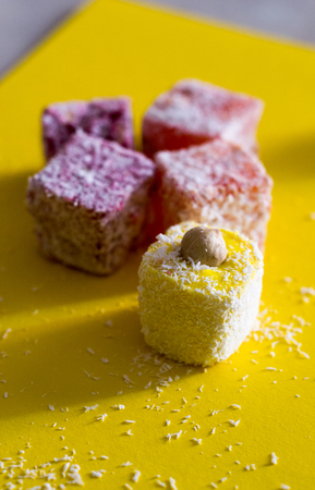 Turkish delight with nuts on yellow background. Selective focus, copy space background, top viewの写真素材