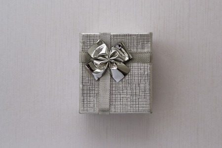 Silver gift box over textured background. Flat lay. Close upの写真素材
