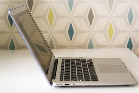 Technology, business and modern life concept. Close up of open laptop computer on white tableの写真素材