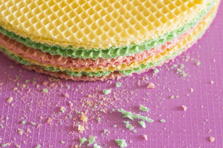 Colourfull waffles on purple desk. Textured abstract background. Close up.の写真素材