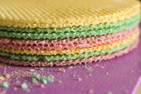 Colourfull waffles on purple desk. Textured abstract background. Close up.の写真素材