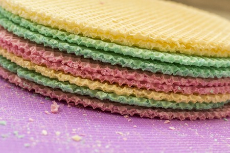 Colourfull waffles on purple desk. Textured abstract background. Close up.の写真素材
