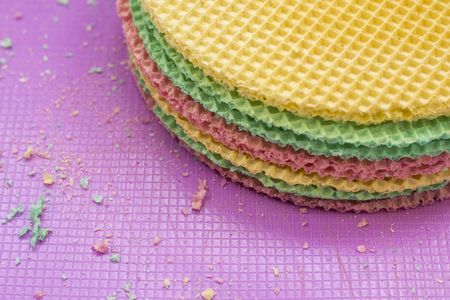 Colourfull waffles on purple desk. Textured abstract background. Close up.の写真素材