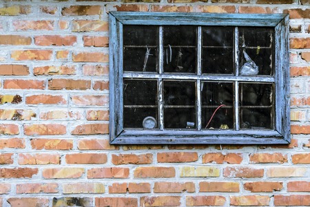 Dark blue old window on red brick wall. Vintage tone. Copy spase and backgroundの写真素材