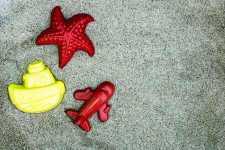 Beach toy on the sand. Flat lay. Advertising holiday concept. Copy spaceの写真素材
