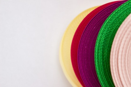 colored ribbons in rolls on a white backgroundの写真素材