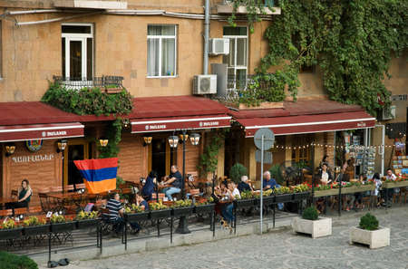 YEREVAN, ARMENIA, 21 SEPTEMBER, 2018 People relax in the evening in a street cafe