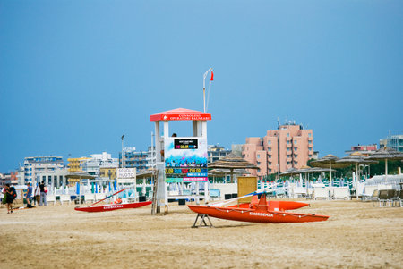 RIMINI, ITALY, JULY 29, 2014 Rescue tower and boats on the beach of Marina Centro on a cloudy dayのeditorial素材
