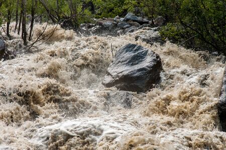 Mudflow, turbulent river in the mountains, flood and stoneの写真素材
