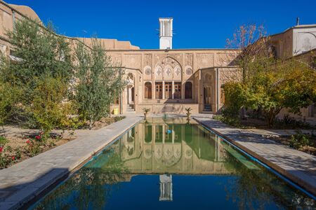 Kashan, Iran, Novemver 10.2016: The courtyard of the Boroujerdi historic house, now museum, built by a persian architect Ustad Ali Maryam. The white tower of traditional windcatcher and fountain poolのeditorial素材
