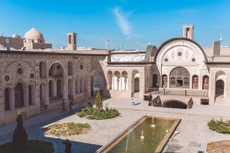 Kashan, Iran, Novemver 10.2016: The courtyard of the Tabatabaei House with ornamental wall decoration, pool, fountains and some tourists. It was built by a persian architect Ustad Ali Maryamのeditorial素材