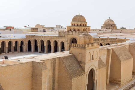 View of Great Mosque of Kairouan in Tunisia. The Mosque in the desert. Massive wall and gallaries