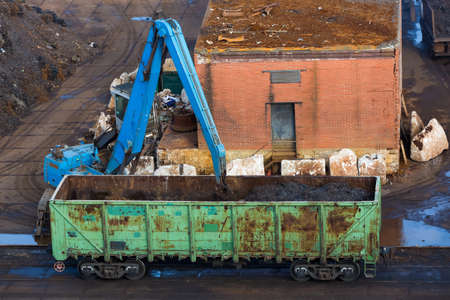Unloading of a freight car with a crane. Freight wagon. Port unloading