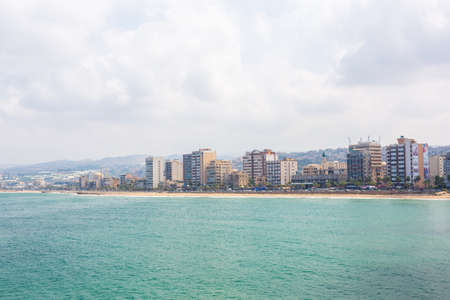 Sidon, Lebanon, August 08.2018: Panoramic view of Sidon or Saida city. City embankment, beach, Mediterranean Sea, buildings and mosquesのeditorial素材