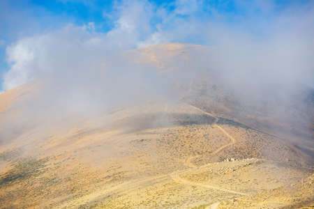 Lebanese mountain landscape. Mountain trail in the clouds at the top. Active recreation with...