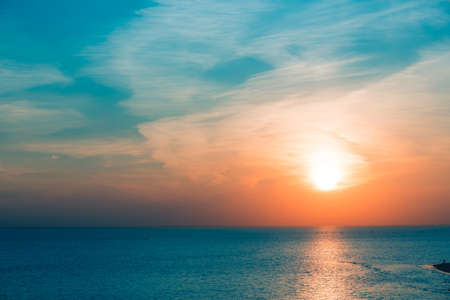 Stunning sunset at Gulf of Finland in Saint Petersburg. Sun disc over the horizon. Bright backlit...