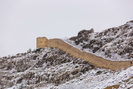 Gunib fortress in winter in the snow. Fortress of Imam Shamil in Dagestan, Russia. Tower on top of a mountain. Ruins of a stone wall. Winter landscapeの写真素材
