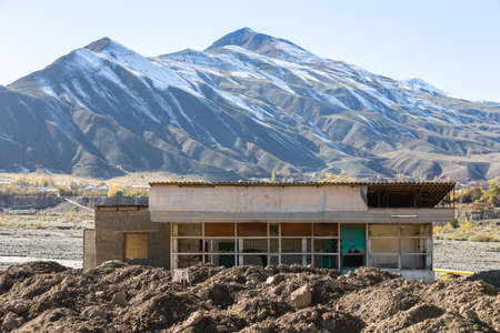 Abandoned shop in the Akhty village, Dagestan, Russia. Devastation and the mountains on the...