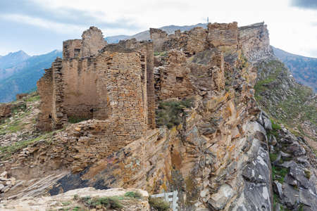 Old stone houses in Goor village, Dagestan, Russia. Ancient houses on ledges of rocks. Ruins of the abandoned village. Panoramic view of the ancient Goor settlement among the mountainsの写真素材