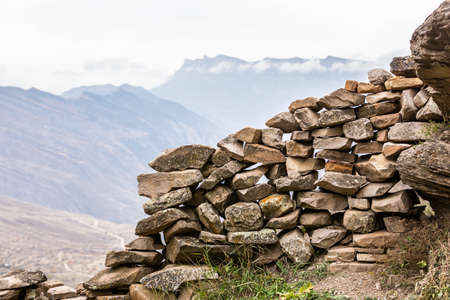 Ancient stones of old houses. Stone ruined wall. Panoramic mountain viewの写真素材
