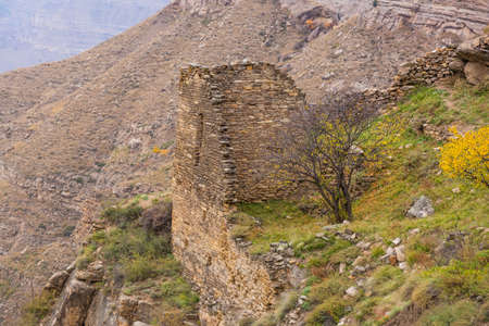 Old stone town Kakhib, Dagestan, Russia. Remains of masonry close up. Panoramic view of ancient walls and the mountainsの写真素材