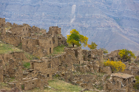 Old ruins in Shamilsky District, Dagestan, Russia. Ancient houses on ledges of rocks. Ruins of the abandoned village. Panoramic view of the ancient settlement among the mountainsの写真素材